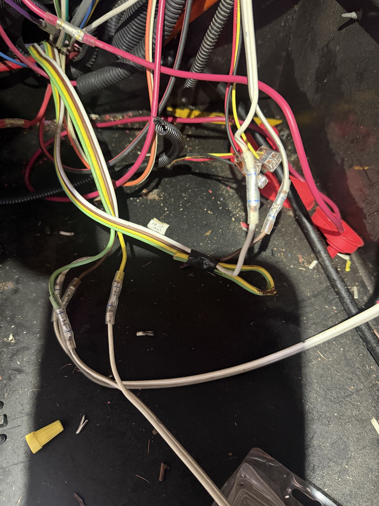 RV 12V wiring harness repair with labeled gauge wire, lever connectors, and heat-shrink terminals inside a dark compartment