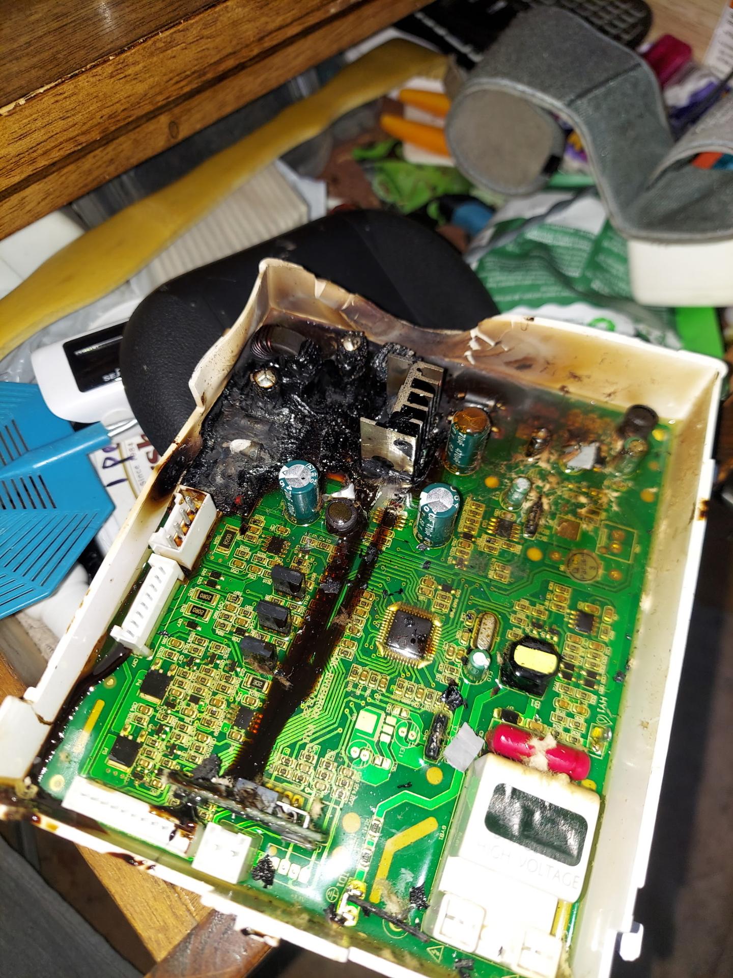 RV appliance control board with burned, melted plastic housing and scorched circuit traces removed for diagnosis