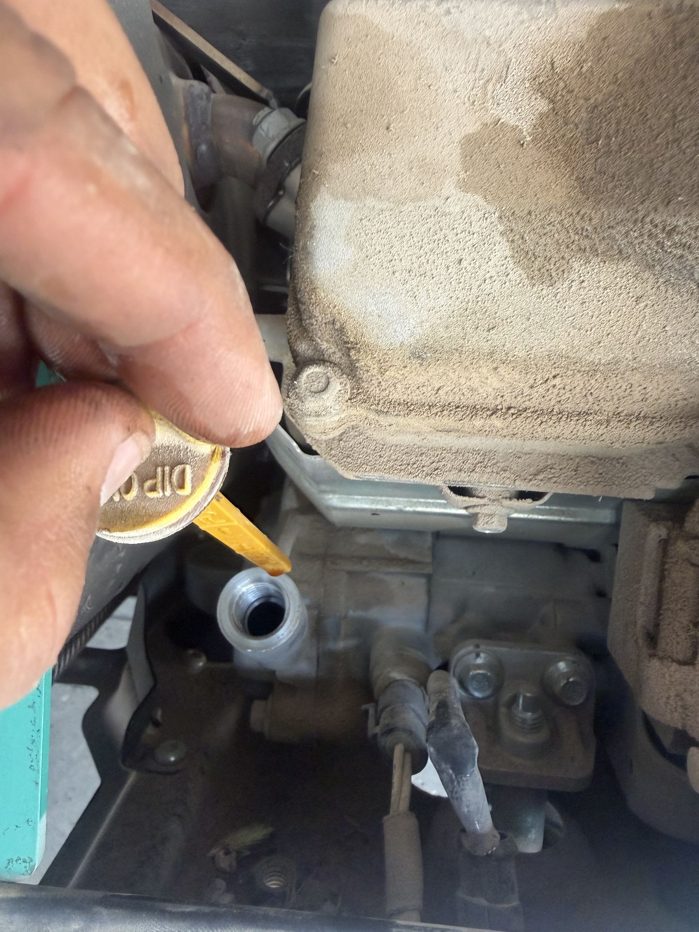 Technician checking the dipstick on an RV onboard generator during an oil change and service